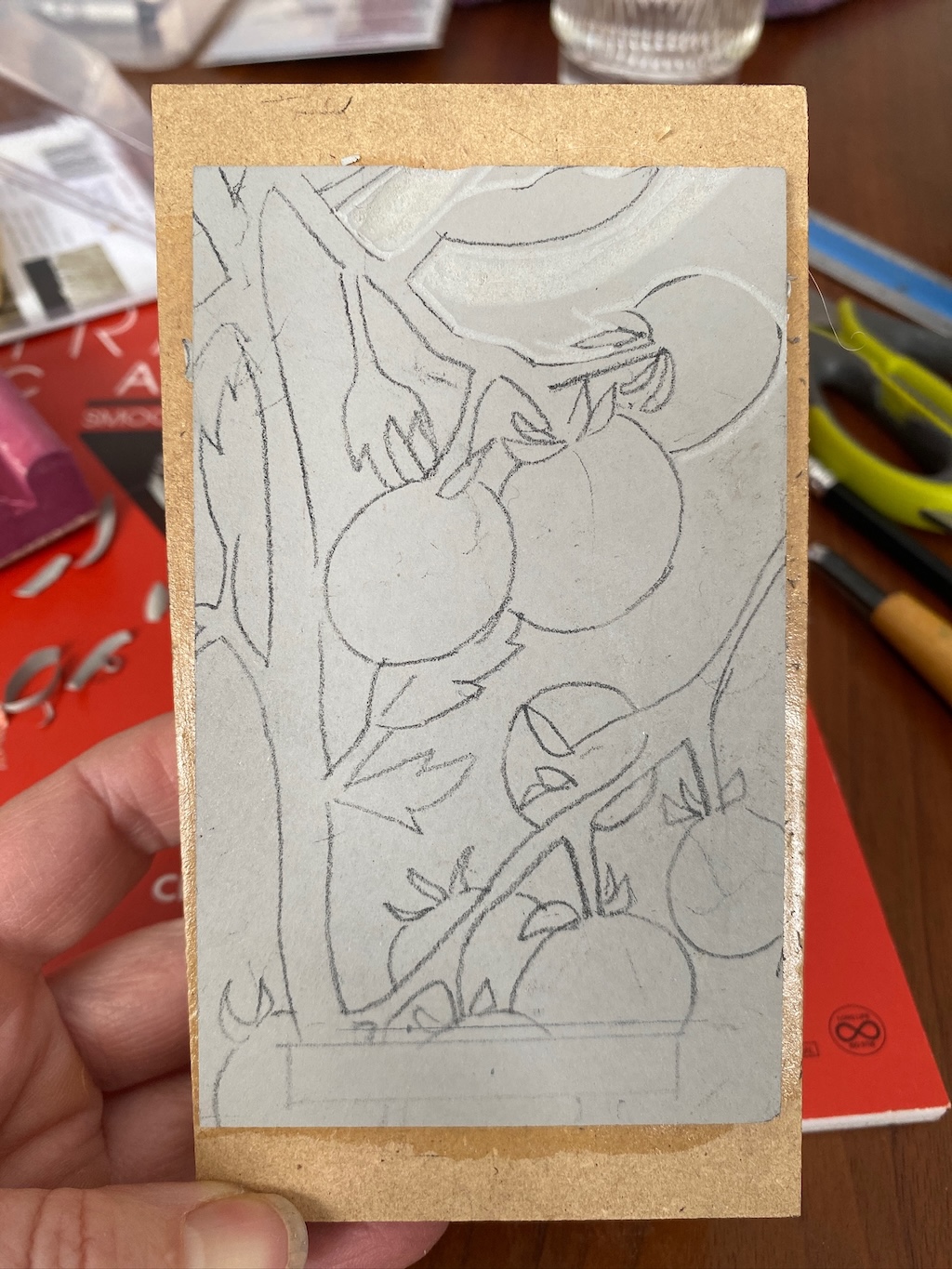 Mounted piece of linoleum, with a pencil sketch of tomatoes.