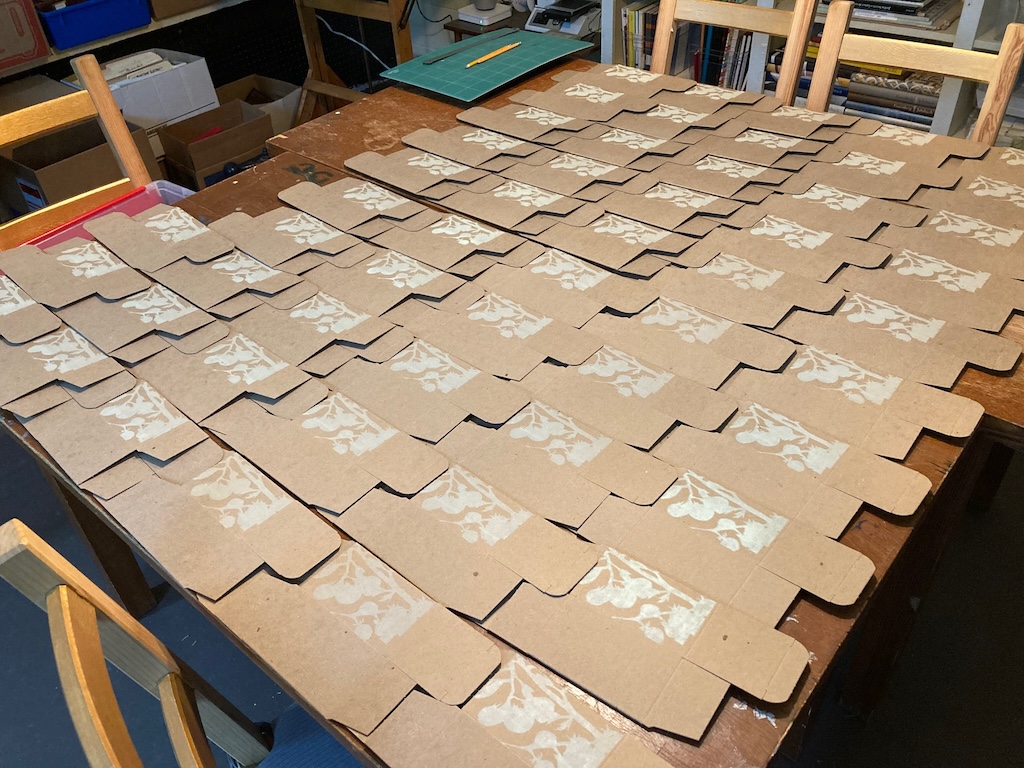 Many boxes set out to dry after printing the first green layer.