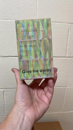 Box overprinted with "Give me away"