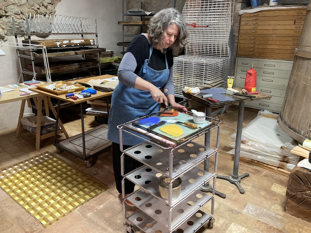 Lisa rolling out inks in the letterpress shop.