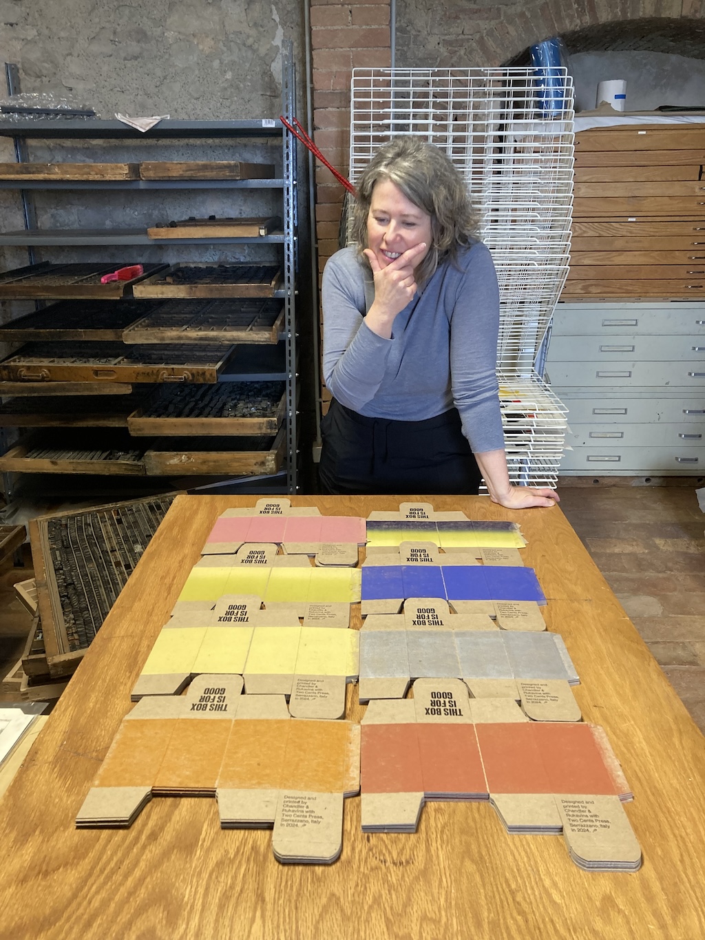 Lisa looking at different colours we'd printed of boxes.