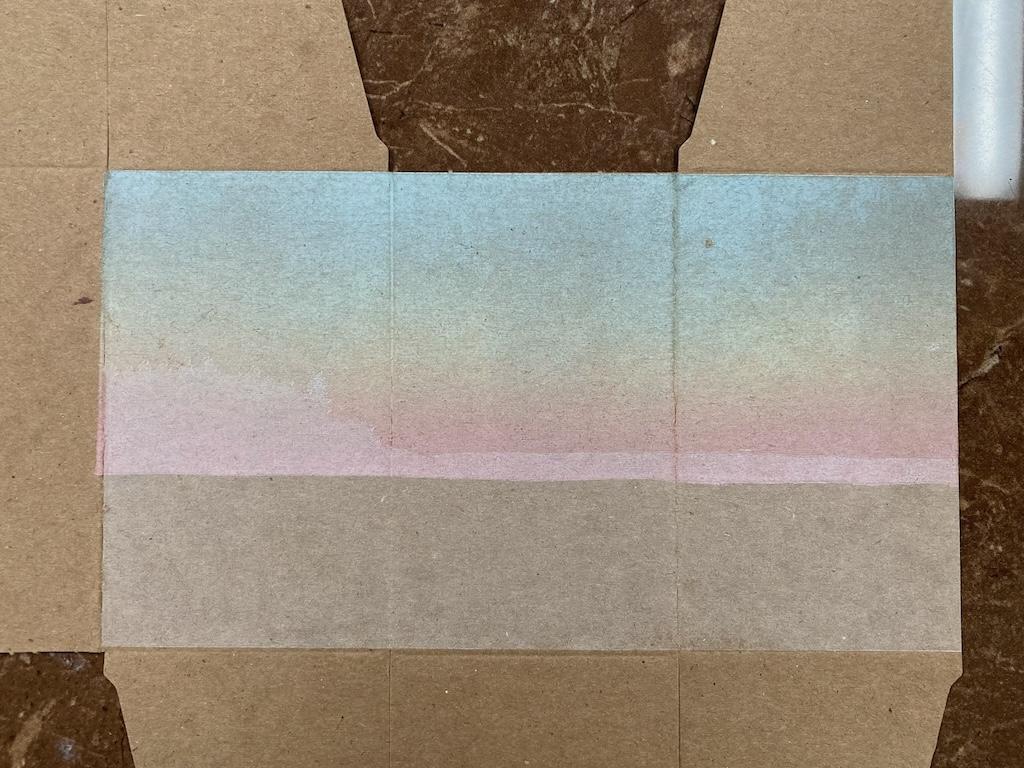 The box with both the sky and the silvery-white layer printed.