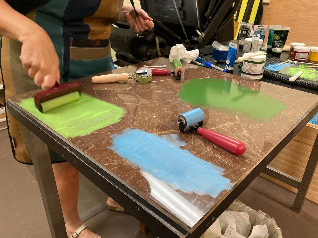 The inking table, with two shades of green ink and one of blue ink, all rolled out.