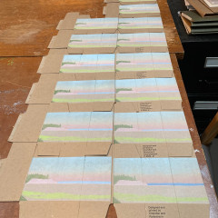 Boxes laid out to dry, printed with early layers only.