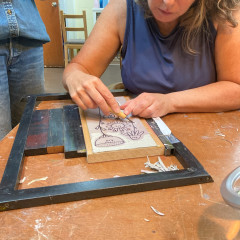Lisa carving the box lino block.