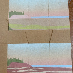 Two printed boxes, one with the dark red layer, one without, to show the contrast.