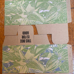 Two printed boxes, one with the blue layer and one without, to show the contrast.