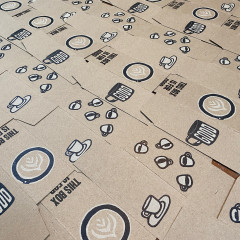 Printed boxes, unassembled, set out to dry.