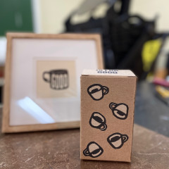 Finished box, photographed in front of a framed "Good Coffee" print.