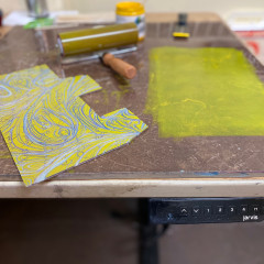 The carved block with yellow ink.