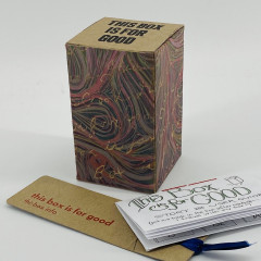 Printed box, with bookmark and zine in front.