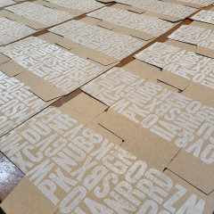 A white layer printed on boxes, laid out to dry