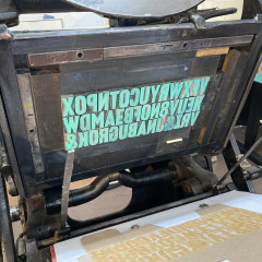 The chase in the printing press, inked with green ink