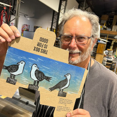 Printmaker Edgar Blass holding his box in front of him
