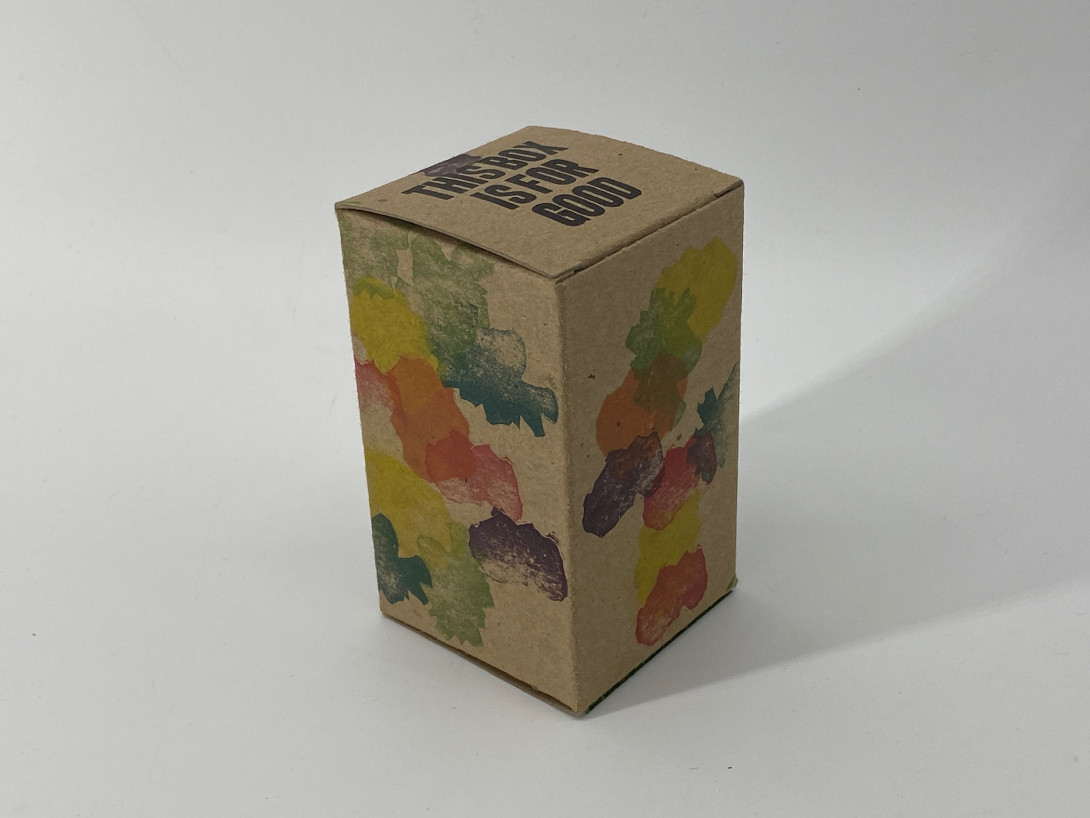 A brown cardboard box on a white background. Printed on the box or abstract shapes in a rainbow of colours