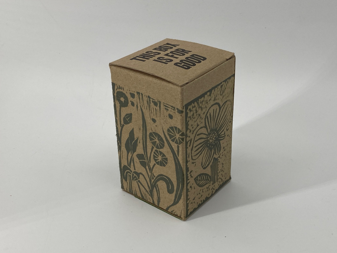 A brown cardboard box on a white background. Printed on the box are images of flowers