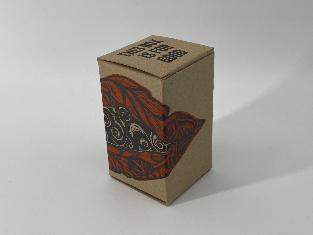 A brown cardboard box on a white background. Printed on the box, And bold red and black, is a giant set of lips